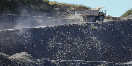 Image of a haul truck travelling up an incline at a quarry.