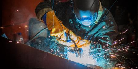 Worker welding metal