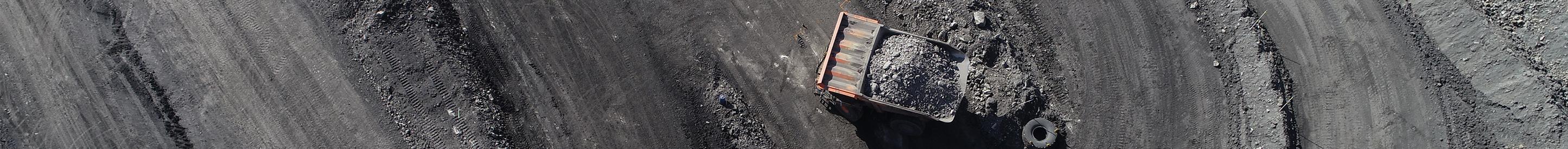 Aerial view of haul truck in precarious position at mine